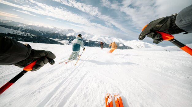 INTERSPORT Rent Skiing POV Group First-person view of a skier on a mountain